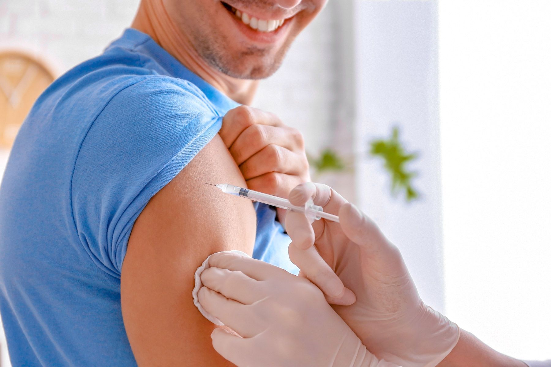 doctor vaccinating male patient