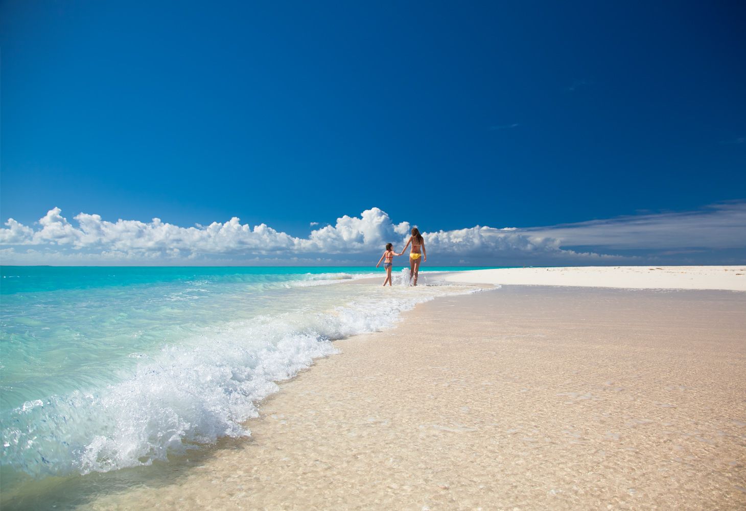 Family walking along Beaches Turks and Caicos Beach